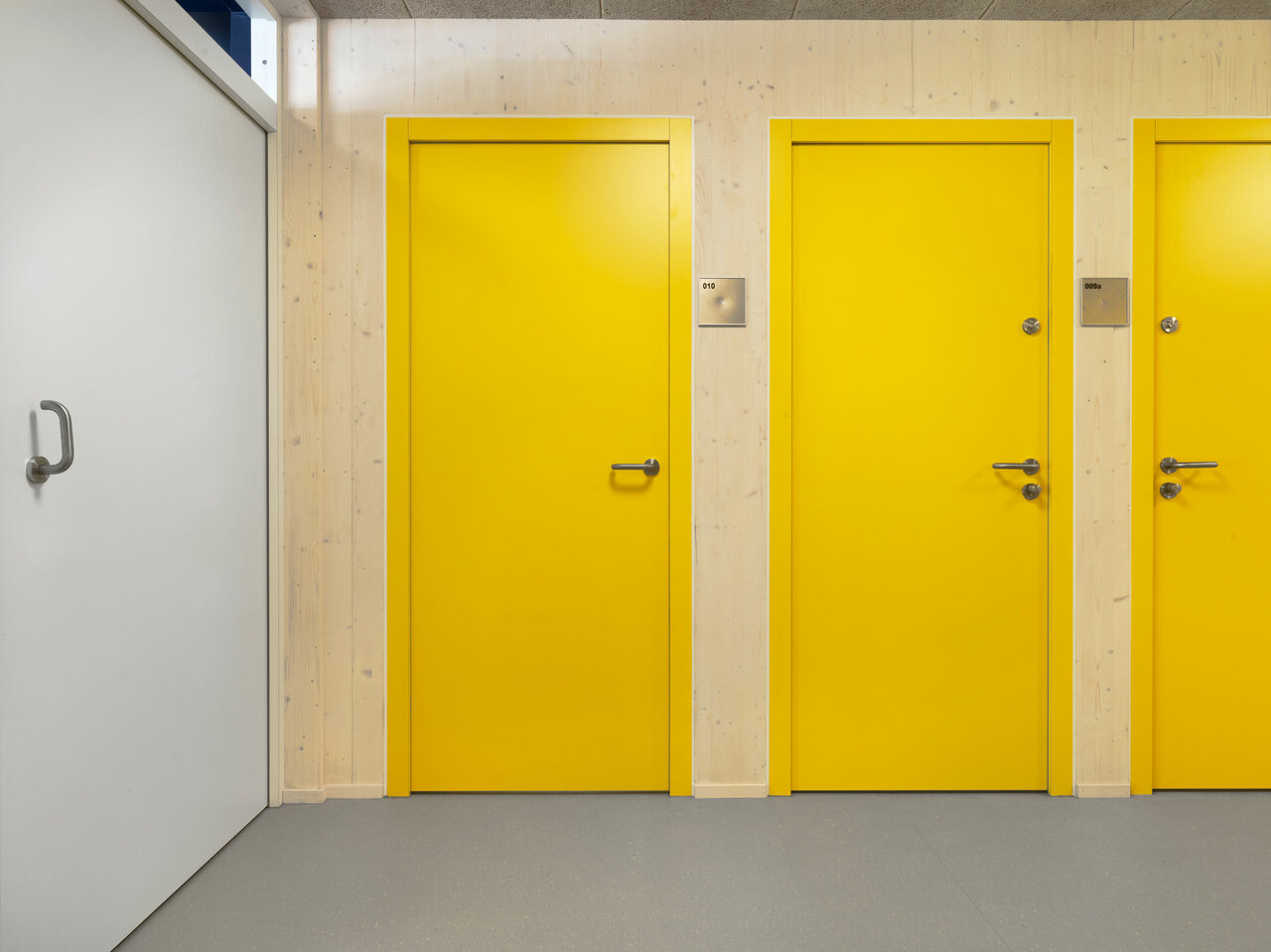 Innenaufnahme mit gelben Türen Schulbau Barnet-Licht-Platz Leipzig